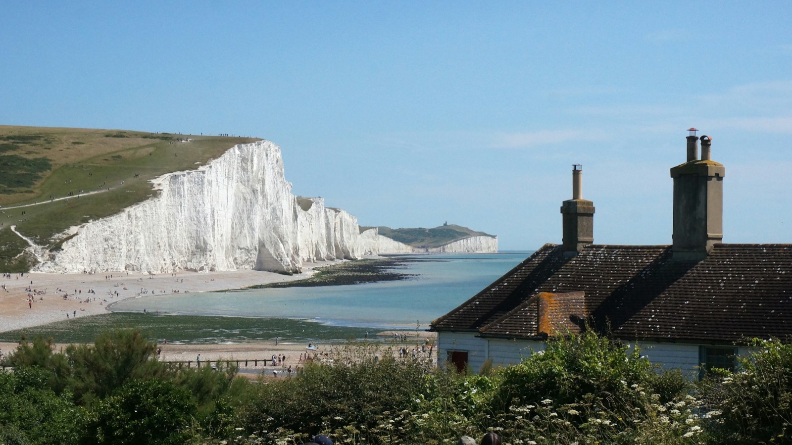 The Seven Sisters chalk cliffs seen from Seaford Head, with the coastguard cottages in the foreground.